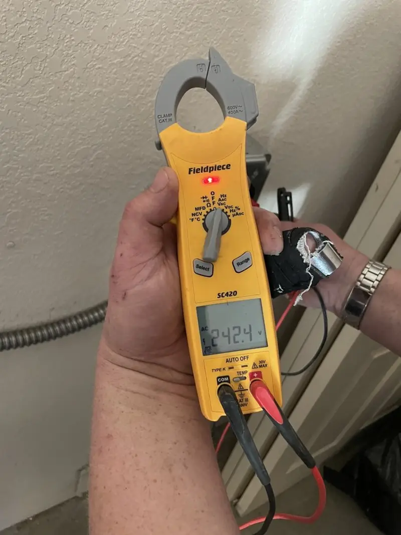 Voltage testing with clamp meter during Electrical Installation Services in Oakland